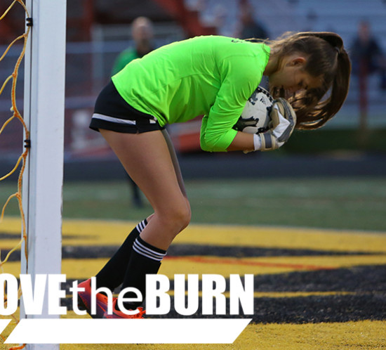 High School Soccer Goalie makes a Save